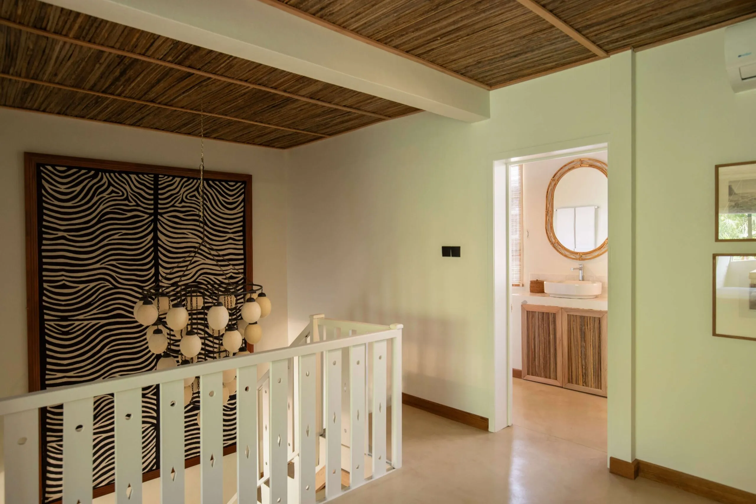 A handcrafted Indian carpet paired with an antique ostrich egg chandelier